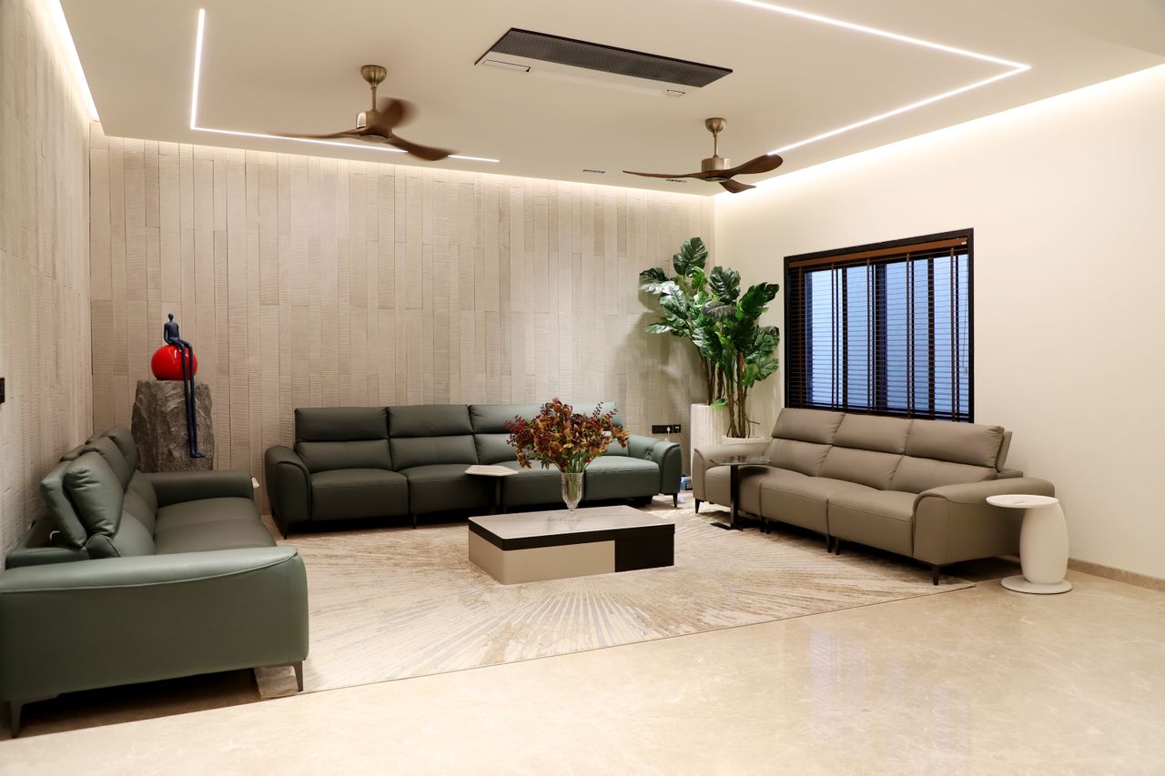 hero-img-02 Spacious modern living room featuring green sofas, indoor plants, and minimalistic decor.