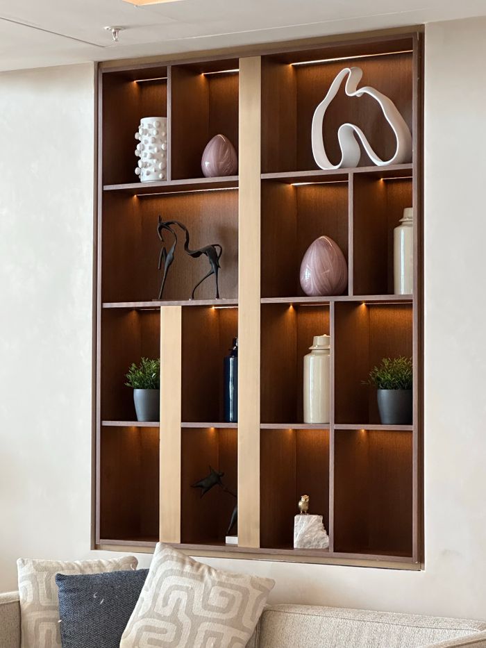 gallery-1 Stylish wooden wall shelf with decor items in a modern living room.